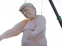 A 43-foot-tall naked statue resembling Donald Trump is displayed in a fenced-in lot near Interstate 15 north of Las Vegas, Nevada.