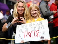 Fans hold a sign for Taylor Swift