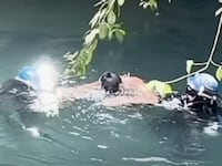 Rescuers guide Erasto Crisanto Valdez to safety after finding him alive inside the flooded cave system.