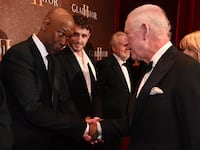 LONDON, ENGLAND - NOVEMBER 13: Pedro Pascal looks on as Denzel Washington meets King Charles III as they attend the Royal Film Performance and Global Premiere of "Gladiator II" in Leicester Square on November 13, 2024 in London, England. (Photo by Eddie Mulholland - WPA Pool/Getty Images)