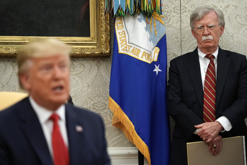 WASHINGTON, DC - JULY 18: White House National Security Advisor John Bolton (R) listens to U.S. President Donald Trump as he and Dutch Prime Minister Mark Rutte talk to reporters in the Oval Office at the White House July 18, 2019 in Washington, DC. According to the Dutch government, the two leaders will discuss defense and security cooperation, especially focused on whether the Netherlands will participate in a global effort to secure international waterways against threats from Iran. (Photo by Chip Somodevilla/Getty Images)