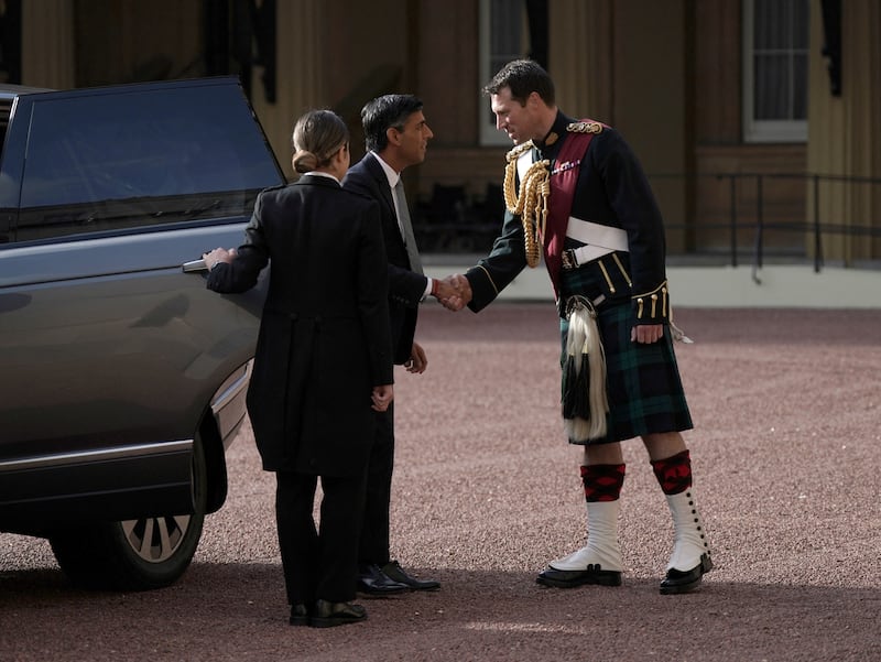 Rishi Sunak is greeted by King Charles III's equerry, Lieutenant Colonel Johnny Thompson, as he arrives at Buckingham Palace, London, for an audience with Charles, October 25, 2022.