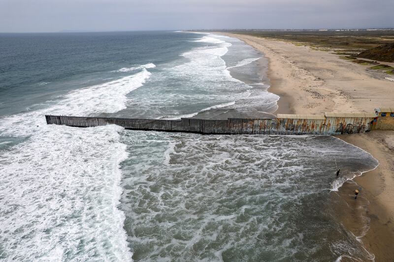 An aerial view shows the Mexico-U.S. border wall extending into the Pacific Ocean near Tijuana, Mexico