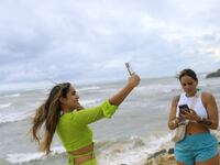 A woman takes a selfie on the beach