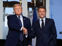 US President Donald Trump (L) shakes hands with France's President Emmanuel Macron during a bilateral meeting on the sidelines of the G7 summit, in Evian, central-eastern France on June 15, 2026. A G7 summit is set to take place June 15 to 17 in the French town of Evian-les-Bains near Switzerland and it will be attended by country leaders as well as the EU's foreign policy chief and ministers from Brazil, Canada, the United Arab Emirates and Turkey. (Photo by Ludovic MARIN / POOL / AFP via Getty Images)
