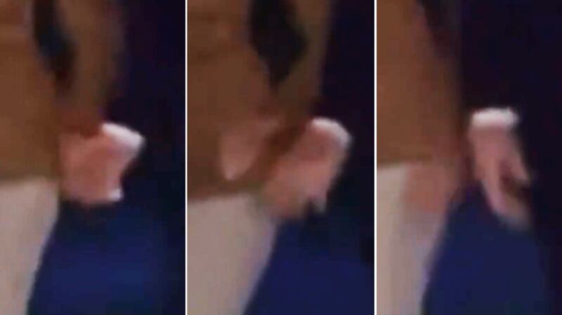 A sequence of frame grabs showing Melania Trump, left, pulling her hand away from Donald Trump.