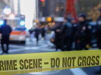 Police line, crime scene taped used to control crowd access during police activity.