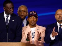 New York City Council Member Dr. Yusef Salaam, Activist Korey Wise and Activist Raymond Santana, representing “the Central Park Five,” stand with Rev. Al Sharpton on stage during the final day of the Democratic National Convention in Chicago.