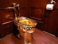 A fully-working solid gold toilet, created by artist Maurizio Cattelan, is seen at Blenheim Palace on Sept. 12, 2019, in Woodstock, England.