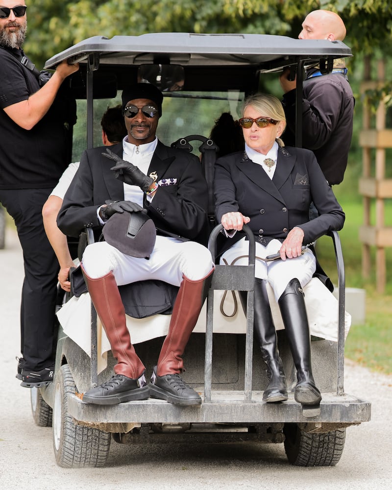 Snoop Dogg and Martha Stewart ride a golf cart in equestrian wear during the 2024 Olympics in Paris.