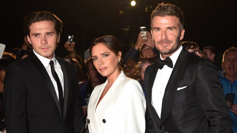 From left: Brooklyn Beckham, Victoria Beckham and David Beckham attend the GQ magazine's 2019 "Men of the Year" Awards at the Tate Modern on September 3, 2019 in London.