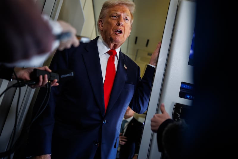 President Donald Trump speaks to members of the media on board Air Force One on October 31, 2025.