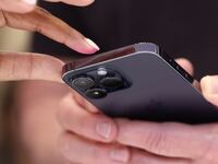 Attendees examine a brand new iPhone 14 Pro