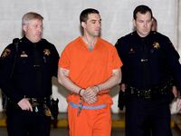 Convicted murderer Scott Peterson is escorted by two San Mateo County Sheriff deputies as he is walked from the jail to an awaiting van March 17, 2005 in Redwood City, California.