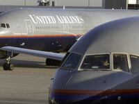 A photo of a United Airlines plane on the tarmac.