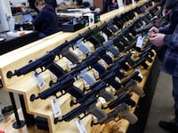 Customers shop for handguns at the Des Moines Fairgrounds Gun Show at the Iowa State Fairgrounds in Des Moines, Iowa
