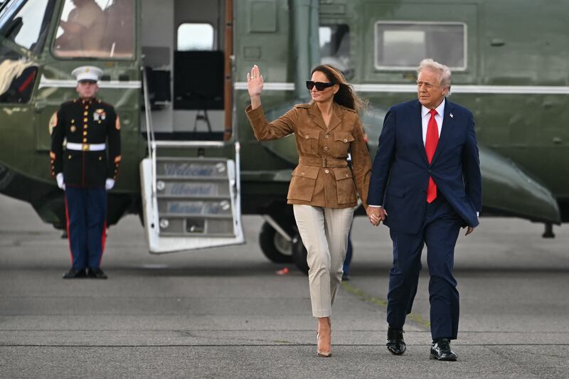 President Donald Trump and First Lady Melania Trump walk across the tarmac toward Air Force One at Stansted Airport, in Stansted on September 18, 2025.