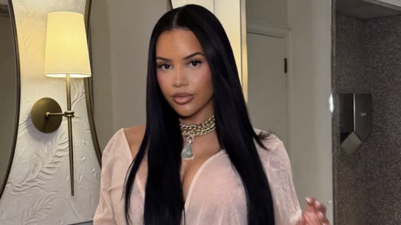 Lateysha Grace in a beige dress