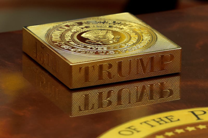 WASHINGTON, DC - FEBRUARY 24: A gold drink coaster box sits on U.S. President Donald Trump's coffee table as he hosts French President Emmanuel Macron for meetings in the Oval Office at the White House on February 24, 2025 in Washington, DC. Macron is meeting with Trump in Washington on the third anniversary of Russia's full-scale military invasion of Ukraine. (Photo by Chip Somodevilla/Getty Images)