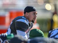 A picture of Blaise Taylor, in uniform, on the sidelines of a college football game.