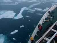 A ship cuts through ice in Arctic Canada.