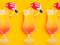 A photo illustration of tequila sunrise orange cocktails with red MAGA hats.
