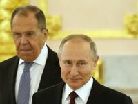 Russian President Vladimir Putin (R) and Russian Foreign Ministers Sergei Lavrov (L)