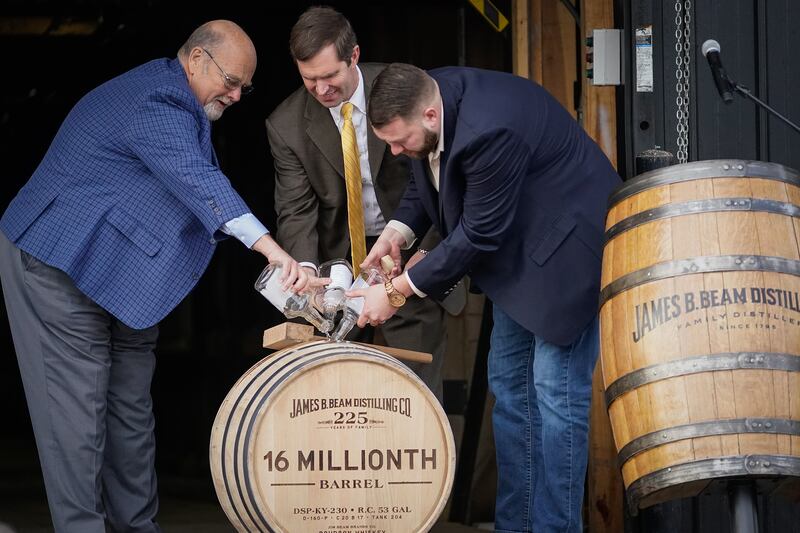 CLERMONT, KY - FEBRUARY 17: Jim Beam Master Distiller Fred Noe (L), Kentucky Gov. Andy Beshear (C) and Freddie Now, Beam Distiller, fill the distillery's 16 millionth barrel of bourbon at the Jim Beam Distillery on February 17, 2020 in Clermont, Kentucky. U.S. whiskey exports have fallen by 27 percent to the European Union, the product's largest export market, caused by retaliatory tariffs imposed by the 27-nation alliance, a trade group said last week. (Photo by Bryan Woolston/Getty Images)