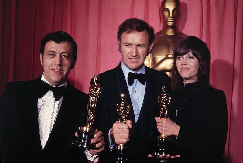 Philip D’Antoni, left, Gene Hackman, center, and Jane Fonda, right, holding their 1972 Academy Awards. D’Antoni produced “best picture” winner “The French Connection,” which Hackman starred in.