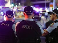 Police keep watch in front of the Westfield Bondi Junction shopping mall after a stabbing incident in Sydney on April 13, 2024.
