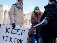 Sarah Baus of Charleston, S.C., holds a sign that reads "Keep TikTok" as she and other content creators Sallye Miley of Jackson, Mississippi, and Callie Goodwin of Columbia, S.C., stand outside the U.S. Supreme Court.