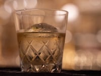 This photo taken on June 19, 2023 shows a glass of Yamazaki whisky, produced by Japanese beverage giant Suntory, sitting on the counter at the Tokyo Whisky Library bar at Minami Aoyama in Tokyo. Japan's Yamazaki distillery marks its 100th anniversary this year with plenty to celebrate, as the country's acclaimed aged whiskys command increasingly eye-watering prices thanks to growing demand and longstanding shortages. (Photo by Richard A. Brooks / AFP) / TO GO WITH Japan-beverage-whisky-suntory, FOCUS by Natsuko FUKUE (Photo by RICHARD A. BROOKS/AFP via Getty Images)