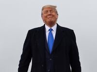 Donald Trump smiles during a campaign event at Capital Region International Airport in Lansing, Michigan, Oct. 27, 2020.