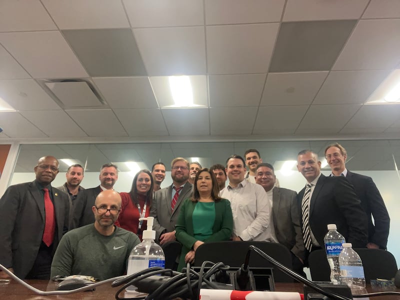Ted Malaska, in a green Nike shirt, poses with colleagues in a photo taken last month.