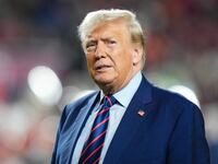 Former President Donald Trump looks on at half time of a game between the South Carolina Gamecocks and the Clemson Tigers at Williams-Brice Stadium.