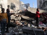 Palestinians inspect a house destroyed in an Israeli strike, amid the ongoing conflict between Israel and the Palestinian Islamist group Hamas, in Khan Younis, in the southern Gaza Strip, December 4, 2023.