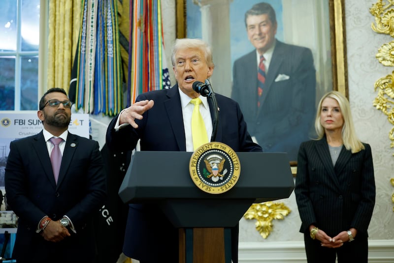 President Donald Trump speaks as Federal Bureau of Investigation Director Kash Patel (L) and U.S. Attorney General Pam Bondi look on