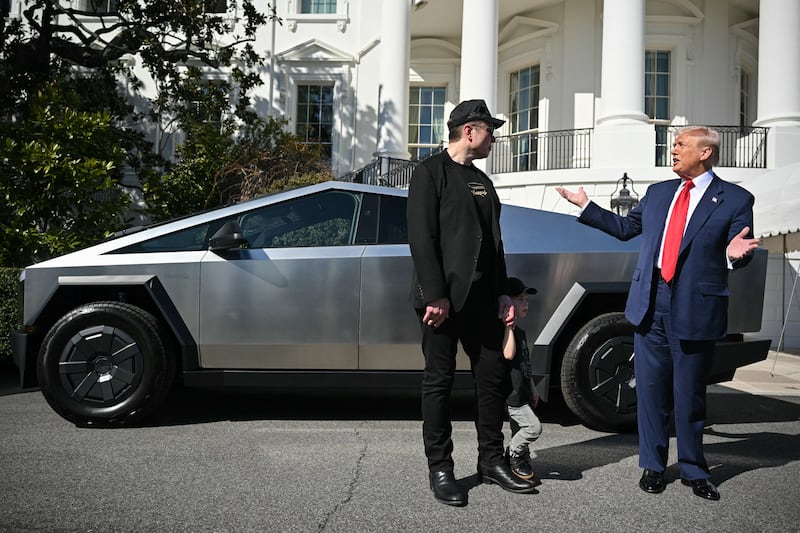 President Donald Trump and Tesla CEO Elon Musk stand next to a Tesla Cybertruck on the South Portico of the White House on March 11.