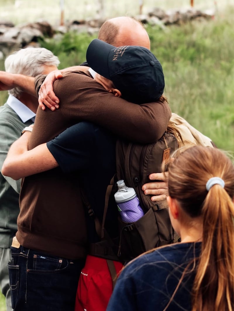 Kate Middleton and Prince William embraced after she climbed the highest mountains in Scotland, England, and Wales.