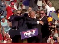 Republican presidential candidate and former U.S. President Donald Trump is assisted by security personnel after gunfire rang out during a campaign rally at the Butler Farm Show in Butler, Pennsylvania, July 13, 2024, in screen grab taken from video.