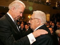 Joe Biden (L) talks with former US Foreign Minister Henry Kissinger on the second day of the 45th Munich Security Conference at the Bayerischer Hof Hotel, southern Germany, on February 7, 2009.