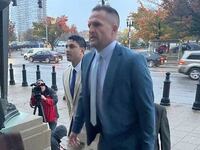 Brett Hankison (right), 47, arrives in court on Monday alongside his attorneys for the beginning of his federal trial