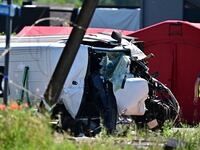 This photograph shows a damaged train car at the site of an accident after a train crashed into a school bus, at the railway crossing Vierhuizen in Buggenhout, some 20kms north of Brussels on May 26, 2026.