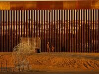 Members of the Texas National Guard stand guard at a wire fence deployed to prevent migrants from crossing into the United States at the U.S.-Mexico border, seen from Ciudad Juarez, Mexico, Oct. 22, 2023.