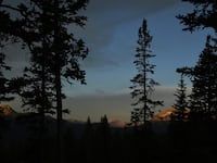 The sun rises on mountains in Colorado. Two sisters and a teenaged son, who were all found partially mummified at a remote Colorado campsite in July after telling family they were living “off the grid,” died of hypothermia and malnutrition.