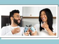 Smiling couple holding Eu Natural Conception for Her and Conception for Him fertility supplements, lifestyle image representing a shared fertility journey.