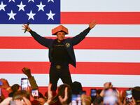 TOPSHOT - Elon Musk wears a Cheesehead hat as he speaks during a town hall in Green Bay, Wisconsin on March 30, 2025. An election to choose a new supreme court judge in the northern US state of Wisconsin wouldn't usually make much noise.