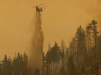A Billings 4AJ helicopter makes a water drop at the Oak Fire near Mariposa, California, on July 26, 2022.