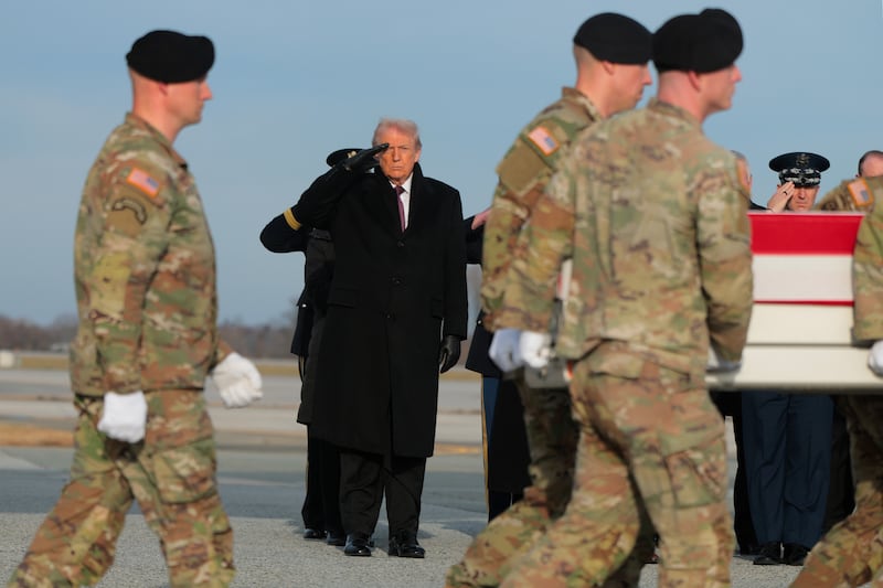 Trump salutes as a U.S. Army carry team moves a flagged-draped transfer case containing the remains of Iowa National Guardsman Sgt. William Nathaniel Howard at Dover Air Force Base.