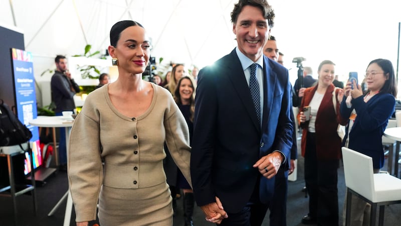Former Prime Minister Justin Trudeau holds hands with Katy Perry as they leave an event during the World Economic Forum in Davos, Switzerland on Tuesday, Jan. 20, 2026.